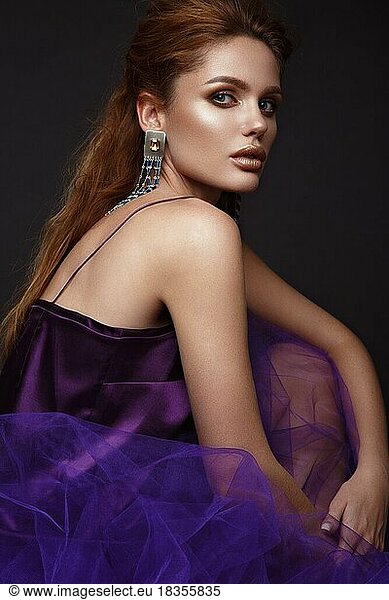 Beautiful sexy girl with sensual lips  fashion hair  purple dress and accessories. Beauty face. Picture taken in the studio