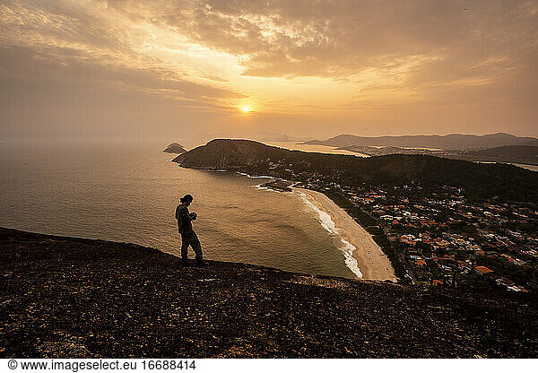 Beautiful sunset view to adventure photographer on hill top