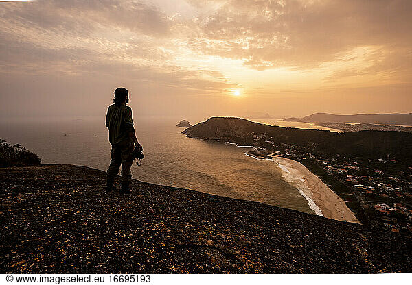 Beautiful sunset view to adventure photographer on hill top