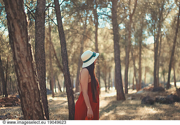 Beautiful view of a girl in a forest during a sunny day