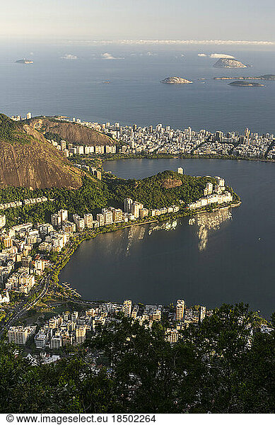 Beautiful view to lagoon city buildings and green rainforest hills