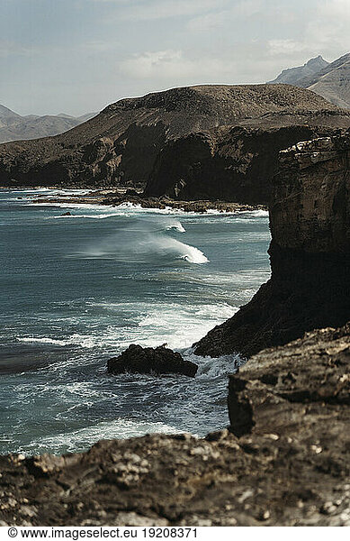 Beautiful volcanic cliffs by sea at Fuerteventura