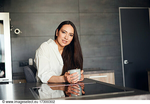 beautiful woman drinking coffee in the kitchen