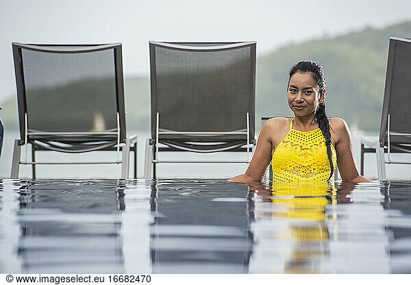beautiful woman enjoying a relaxing time in the pool of luxury resort