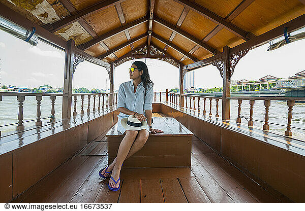 Beautiful woman is relaxing on a river cruise down the Chao Phraya
