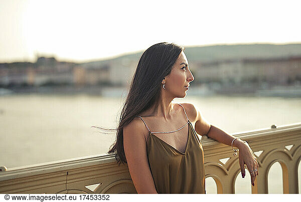 beautiful woman looks at panorama from a bridge