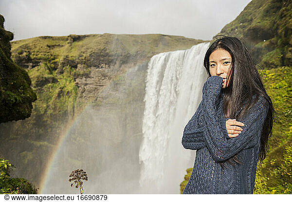 beautiful woman posing at Skogarfoss waterfall in Iceland
