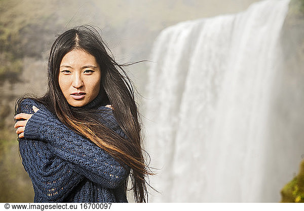 beautiful woman posing at Skogarfoss waterfall in Iceland