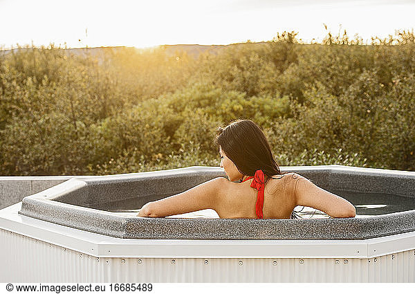 Beautiful woman relaxing in hot tub at holiday villa in Iceland
