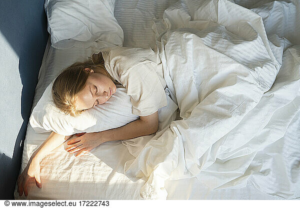 Beautiful woman sleeping in bed in bedroom at home