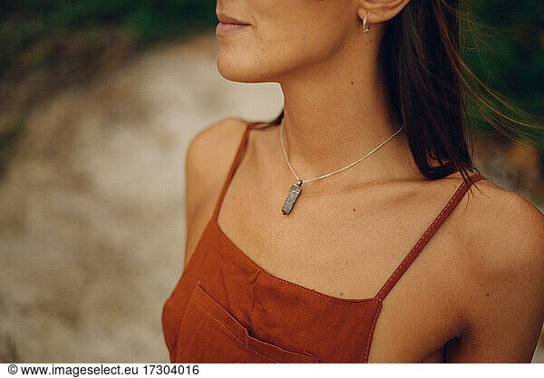 beautiful woman wearing a necklace with stone