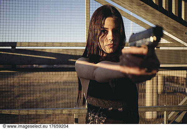 beautiful woman with guns in her hands