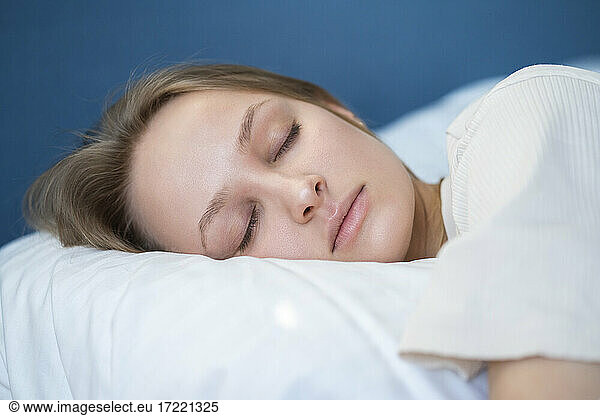 Beautiful young woman sleeping at home
