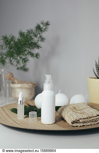 Beauty products on wooden plate