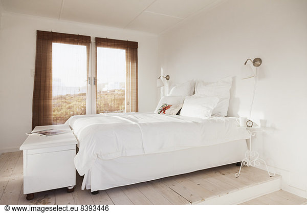 Bed in white bedroom
