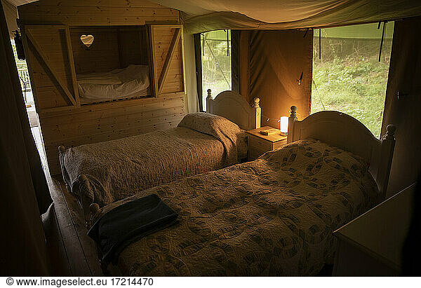 Beds with quilts in yurt cabin