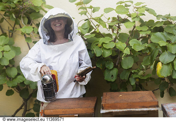Beekeeper holding smoker