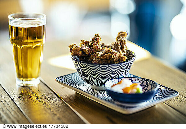 Beer served with fried chicken at restaurant