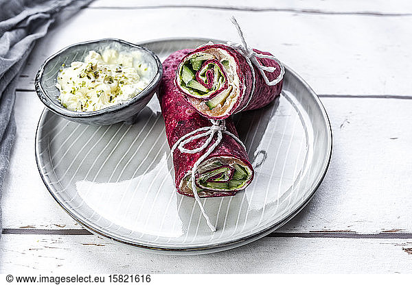 Beetroot wraps filled with ham cheese corn iceberg lettuce cucumbers and cream cheese