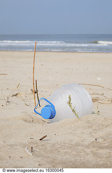 Belgium  empty plastic bottle lying on sandy beach at North Sea coast