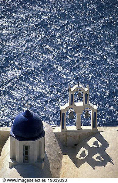Bell tower and windy blue Aegean Sea  Santorini  Greece.