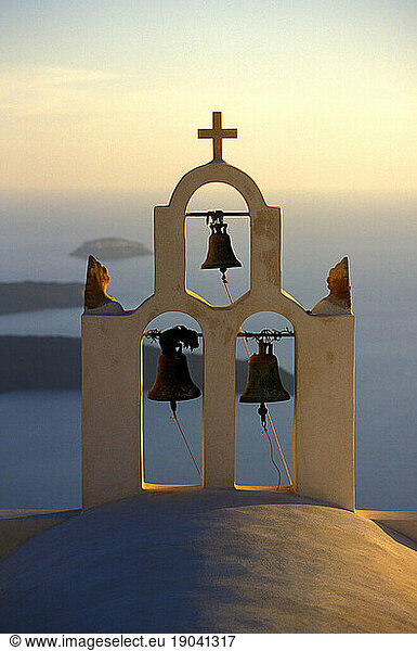 Bell tower and windy blue Aegean Sea  Santorini  Greece.Bell tower and blue Aegean Sea  Santorini  Greece.