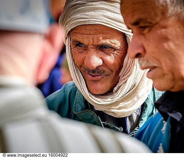 Berber men in conversation at the carpet market in in Tazenakht  southern Morocco  Africa.