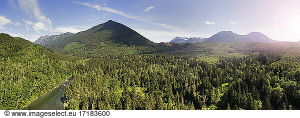 Bergkette und Wälder im Tal  erhabener Blick auf eine majestätische Landschaft und einen breiten Fluss.