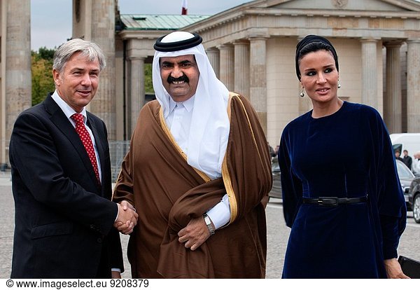 Berlin Major Klaus Wowereit (C)  accompanies the Emir of Qatar  Hamad bin Khalifa Al Thani (L)  and his wife Mozah Binti Nasser Al Missned (R)  to the landmark Brandenburg Gate in Berlin  Germany. Qatar celebrates its National Day in commemoration of the historic day in 1878 when Shaikh Jasim succeeded his father  Shaikh Muhammad Bin Thani  as a ruler and led the country towards unity. The event on December 18 is considered as an opportunity for all Qatari nationals and expatriates to recognise and celebrate what it means to live in modem day Qatar.