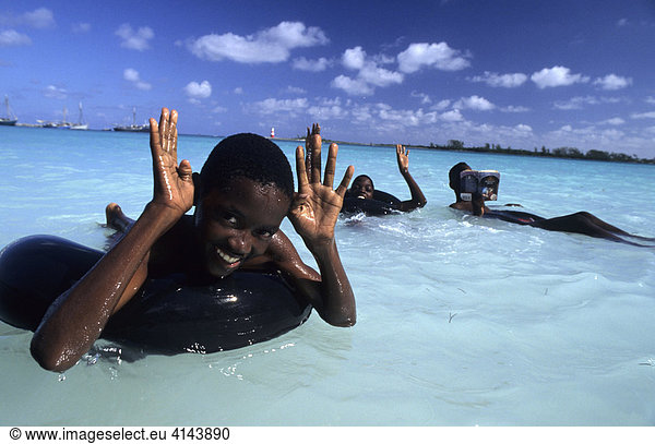 BHS  Bahamas  New Providence: Kids swimming at Cable Beach Independent state in the West Indies  member of Comonwealth of Nations.