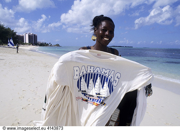 BHS  Bahamas:T-shirt seller at Goodman's Bay beach. Independent state in the West Indies  member of Comonwealth of Nations.