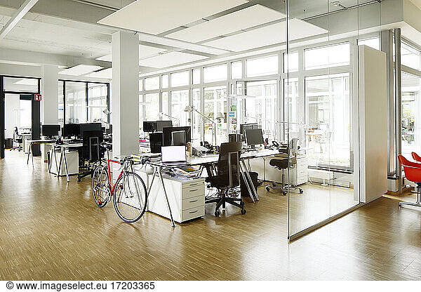 Bicycle at desk in open plan office