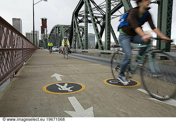 Bicycle commuters head across a bridge in Portland  Oregon.