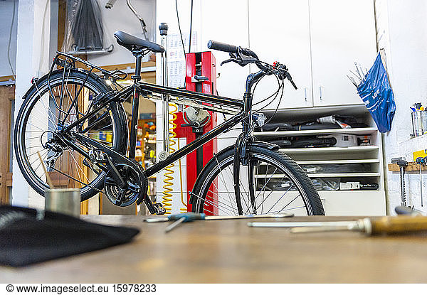 Bicycle in assembly stand in bike shop