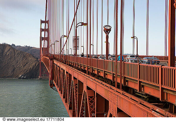 Bicyclists and cars crossing the Golden Gate Bridge.; Golden Gate Bridge  San Francisco Bay  San Francisco  California