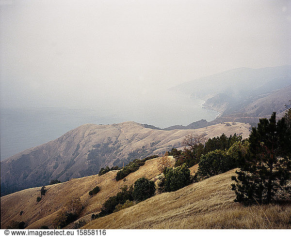 Big Sur mountains in morning with layer of smoke from forest fir