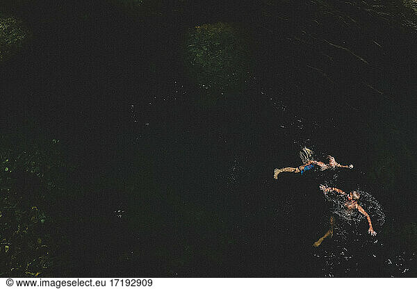 Bird's Eye View of Tween Boys Swimming in Dark Water