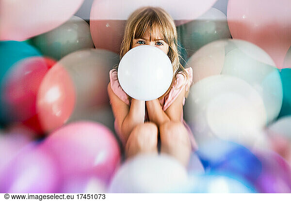 Birthday girl surrounded with balloons