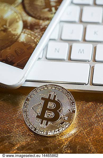 Bitcoin  metal coin  keyboard and smartphone