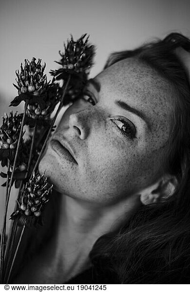 Black and White Close up of Woman with Flowers