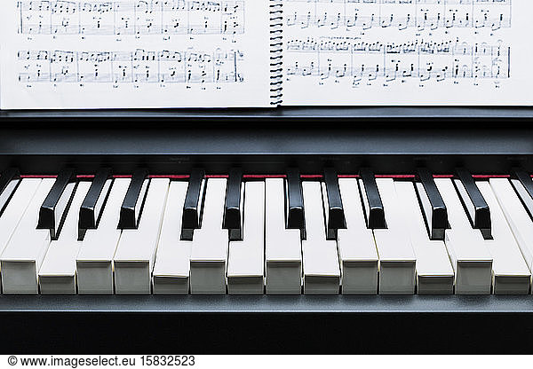 Black and white keys on a electronic piano pulsing an A Chord