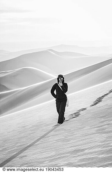 black and white of a lone female hiker in the desert of colorado