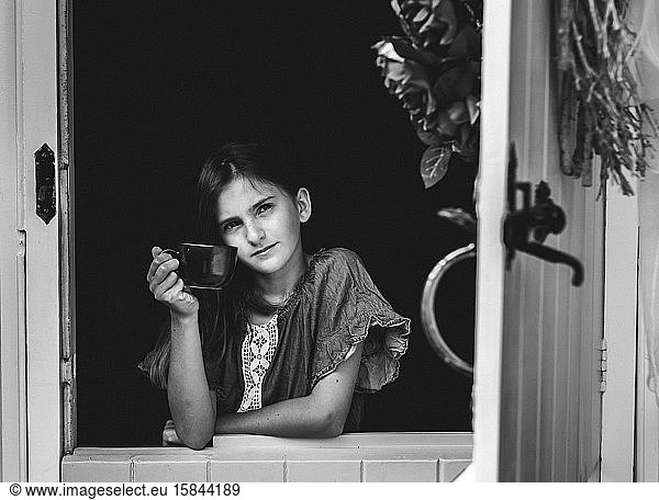 Black and White Portrait of a Young Girl Holding Cup