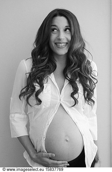 Black and white pregnant woman in white shirt