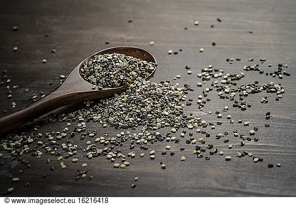 Black and white split urad dhal lentils on a wooden spoon  close up