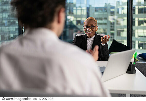 Black businesswoman speaking with colleague