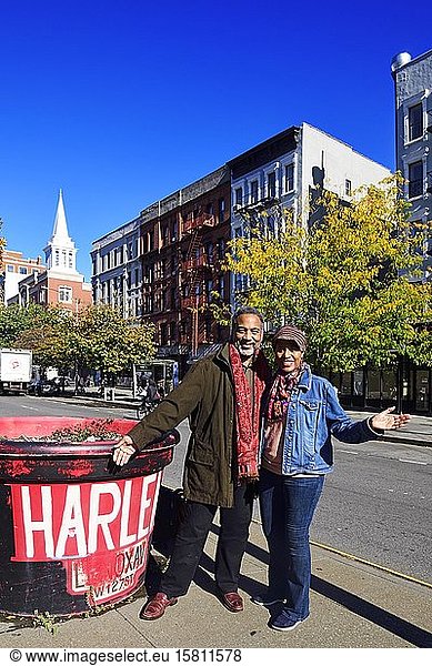 Black couple next to Harlem sign  New York City  USA  North America