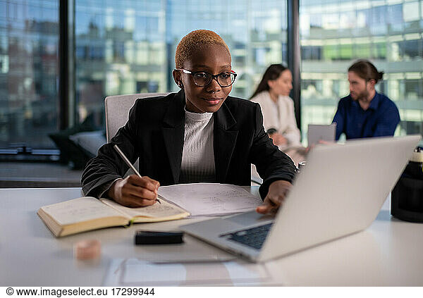 Black female entrepreneur using laptop