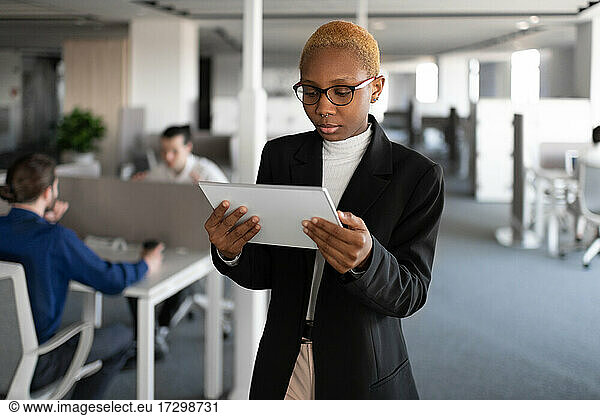 Black female manager browsing tablet