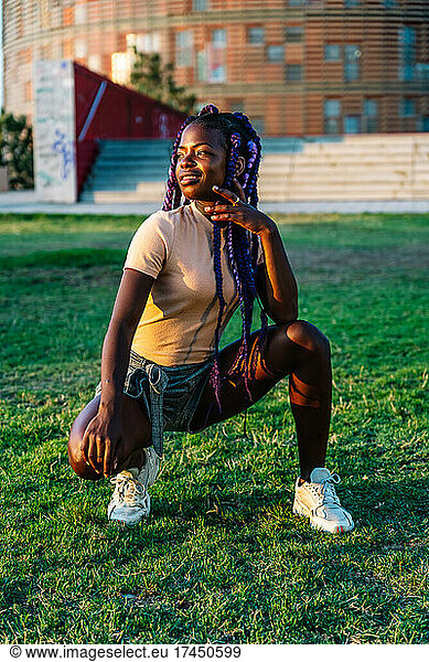 black girl with braids posing in a park